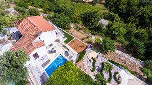 An aerial view of a property with a swimming pool, a red-tiled roof, and a landscaped garden. - Villa Sofija - Three Bedroom Villa with Terrace and Swimming Pool (Zaton Doli)