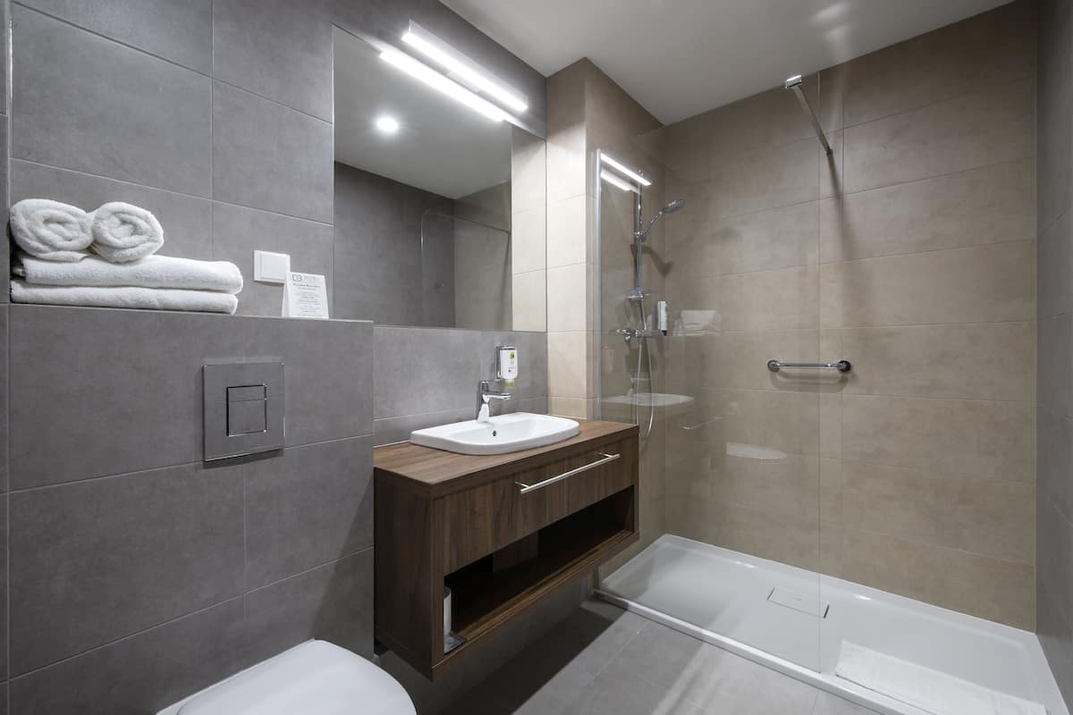 shower, designer toiletries, hair dryer, towels