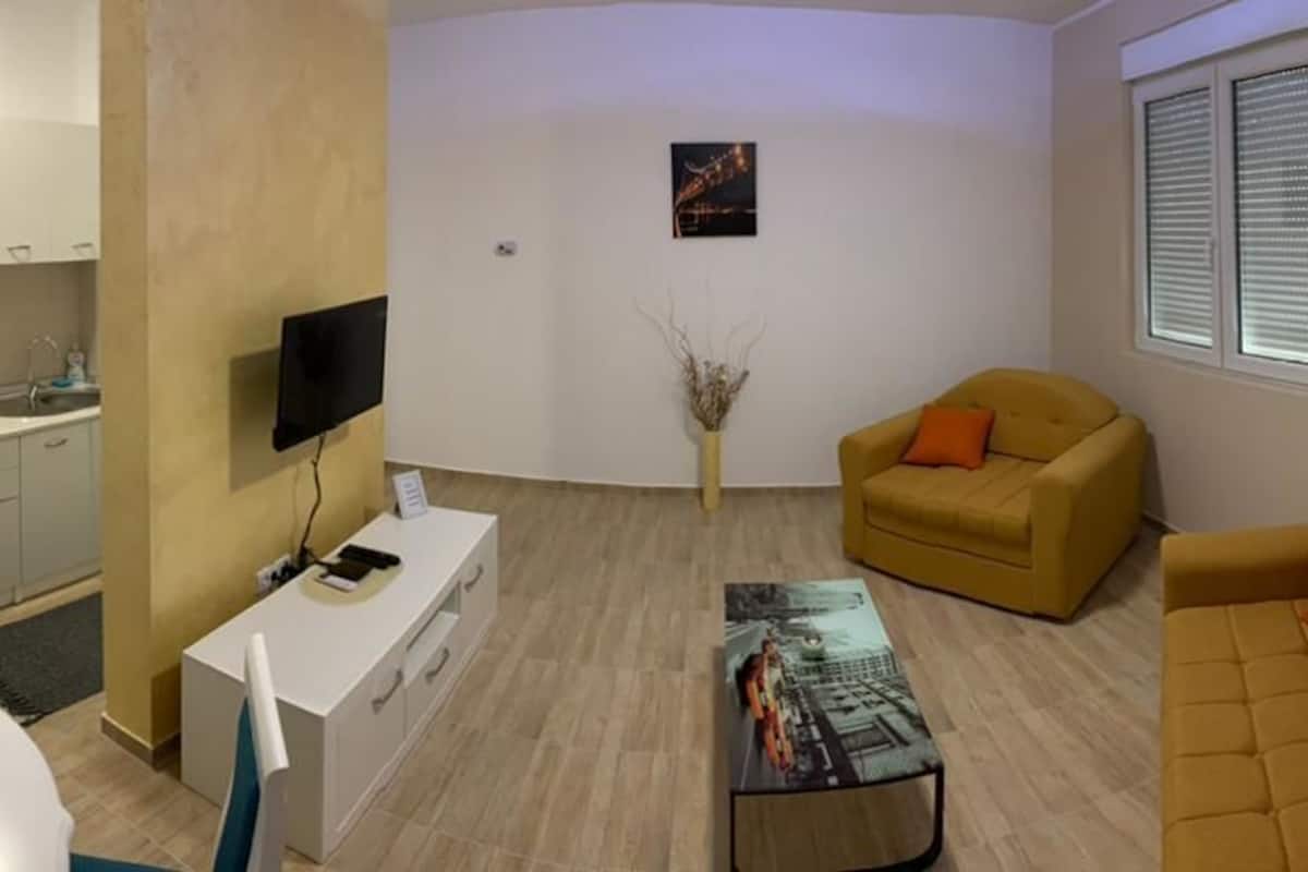 deluxe apartment | living area | flat-screen tv