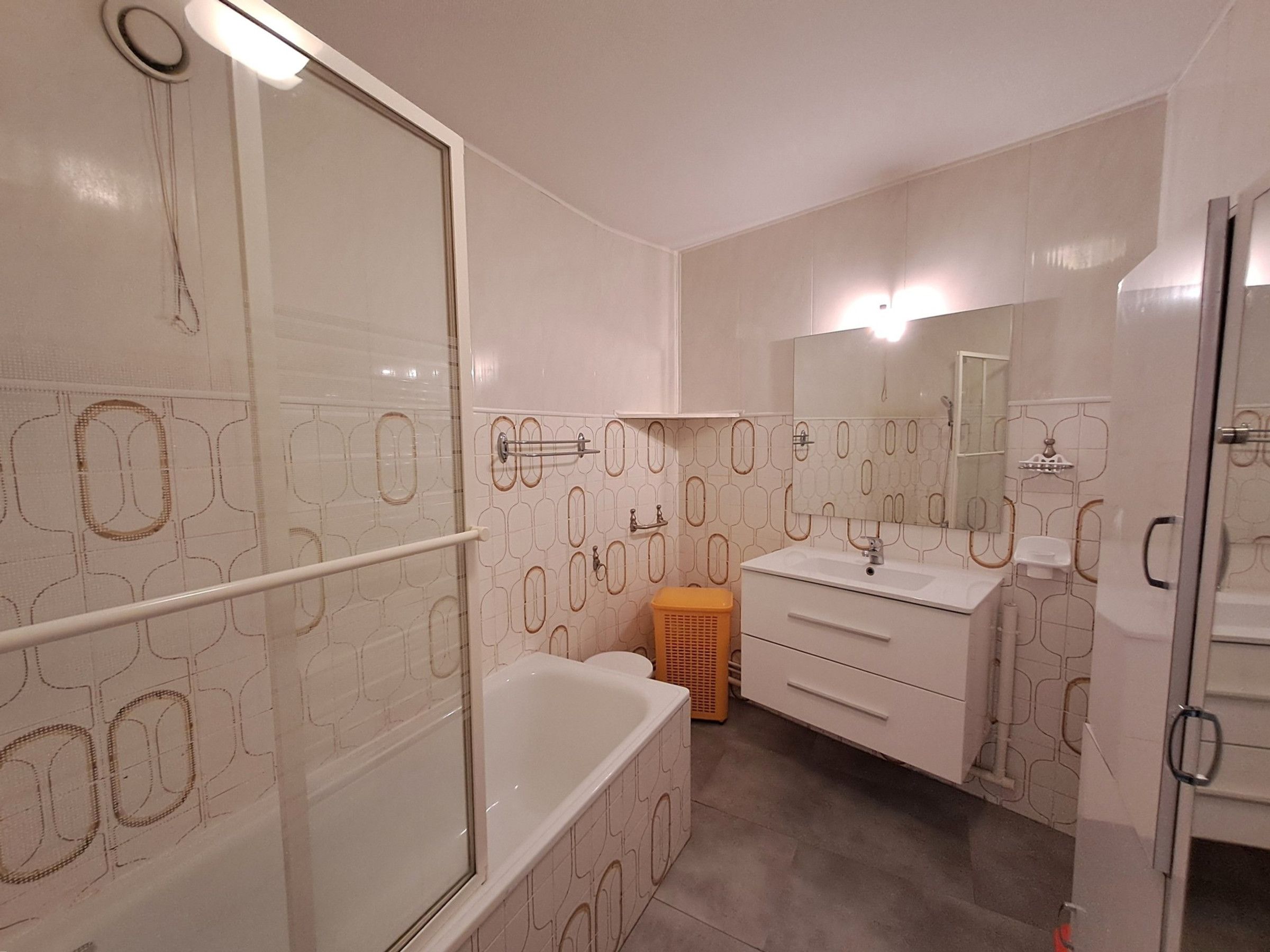 A bathroom with a shower, a bathtub, a sink, and a mirror.