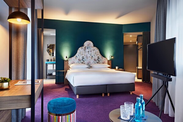 A hotel room with a bed, a desk, a TV, and a bathroom visible through an open door. - Me and All Hotel Dusseldorf Oberkassel, by Hyatt (Düsseldorf)