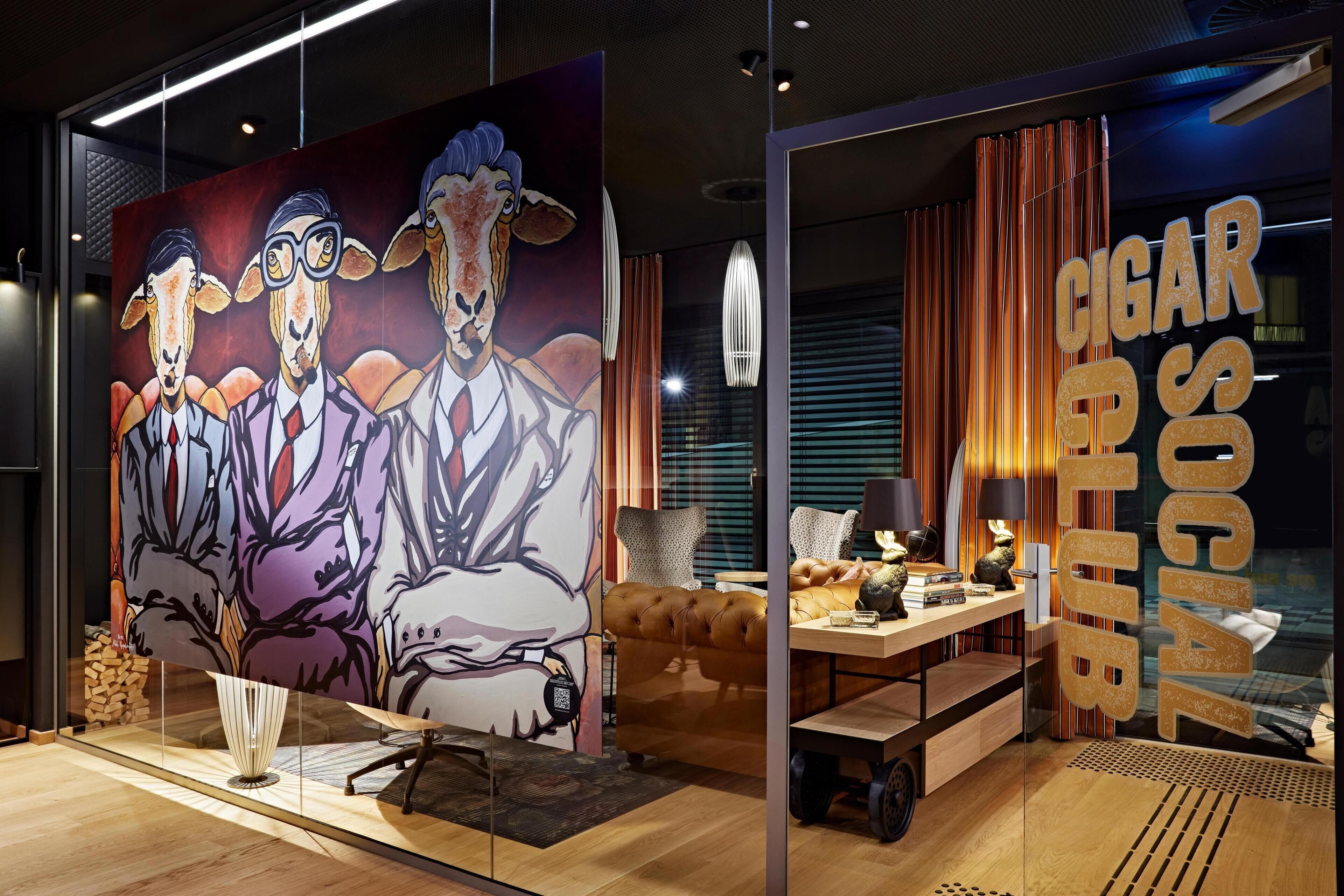 A modern interior with a large painting, a sofa, a dining table, and a glass partition with 'CIGAR CLUB' signage.
