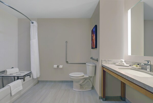 A modern bathroom with a toilet, sink, and shower area.