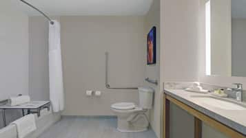 A modern bathroom with a toilet, sink, and shower area.