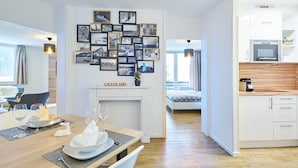 A modern kitchen with white cabinets, a wooden countertop, and a built-in microwave. - Apartment Winterberg - Stylish (Winterberg)