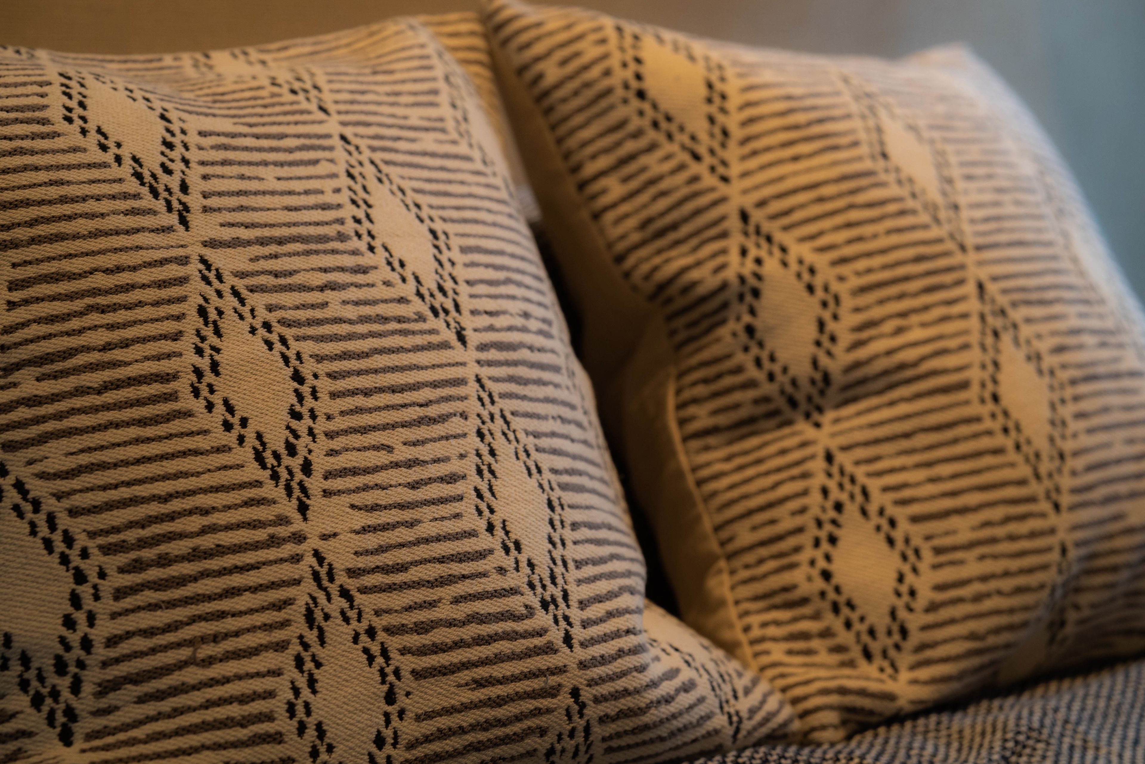 A close-up of a patterned cushion with a geometric design.