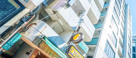 A modern building with a storefront featuring a sign for 'Coco Cafe'.