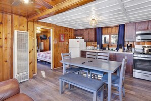 A compact kitchen with a refrigerator, microwave, stove, and sink. - Shore Acres Lodge #451 (Big Bear Lake)