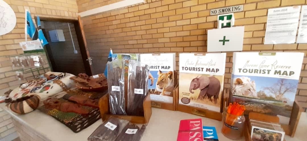 A counter with tourist maps, a 'No Smoking' sign, and a first aid kit.