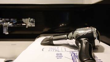 A vacuum cleaner on a white surface with a document underneath.