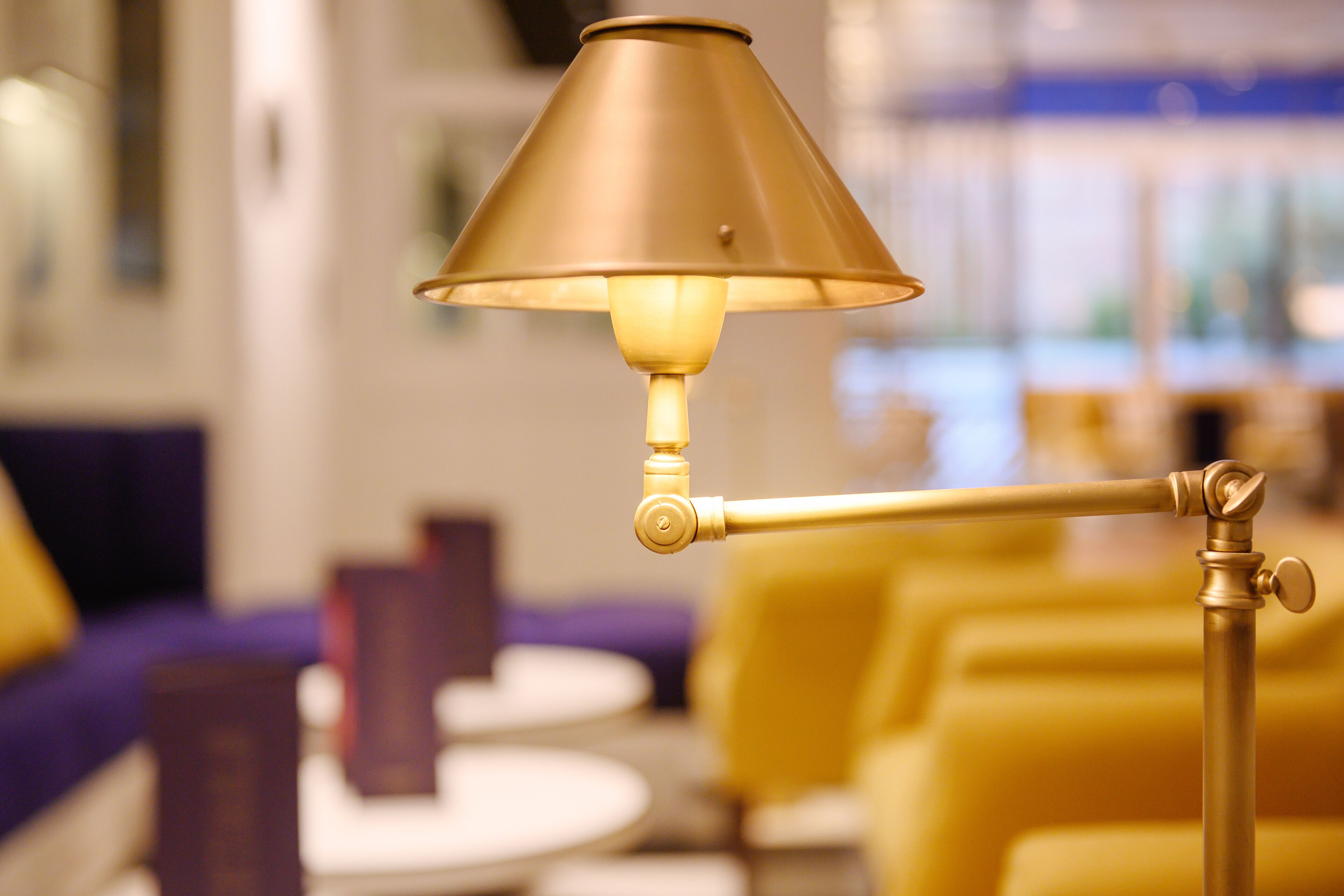 A lamp with a conical shade, a metallic stand, and a base.