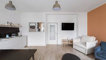 A modern living space with a kitchen, dining area, and seating area.