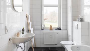 Suite with bathtub | Bathroom | Designer toiletries, hair dryer, towels, toilet paper