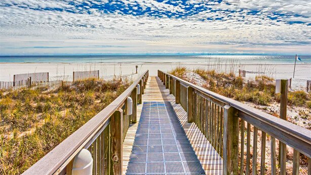 A wooden boardwalk leading to a beach with a clear sky. - Summer House on Romar Beach (Orange Beach)