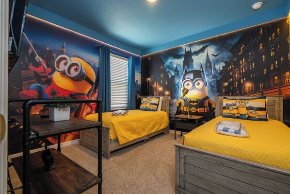 A bedroom with two beds, a desk, and a mural of minions on the wall. - Fantastic 6 Bedroom Near Disney - Solterra Resort (Davenport)