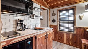 A kitchen with a microwave, coffee maker, and built-in oven. - Log Cabin Inn (Eureka Springs)