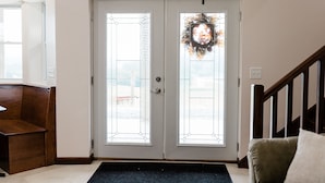 A double door with glass panels and a decorative wreath.