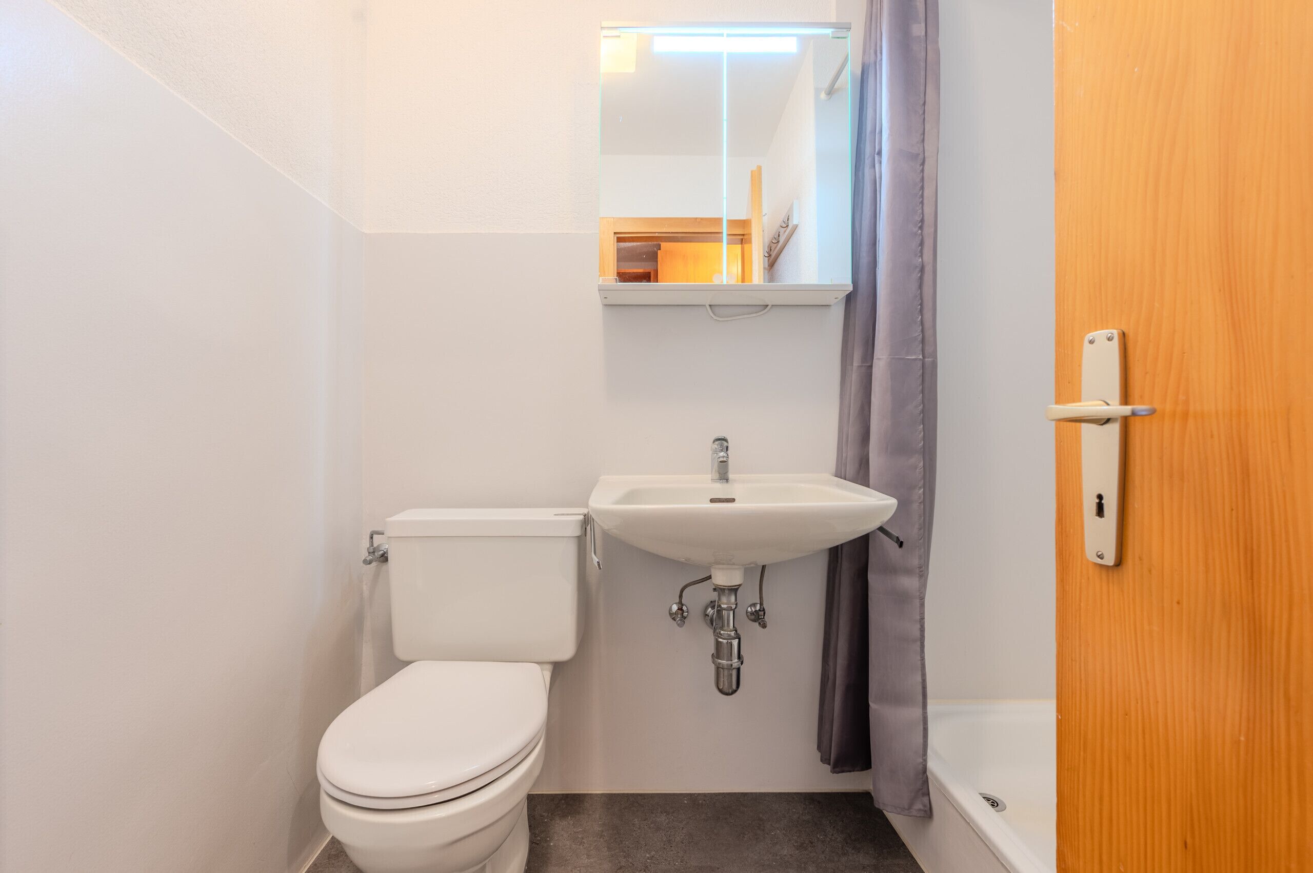 A small bathroom with a toilet, sink, and bathtub.