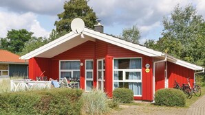 A red building with a satellite dish, numbered 21 and 629, and bicycles parked outside.