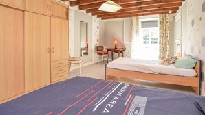 A bedroom with a bed, a desk, a chair, and a wardrobe. - Stunning home in Lonlay l'Abbaye (Lonlay l'Abbaye)