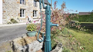 A stone building with a metal water pump in front. - Stunning home in Lonlay l'Abbaye (Lonlay l'Abbaye)