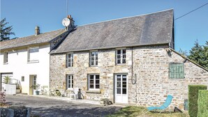 A stone building with a sloped roof, a small balcony, and a door. - Stunning home in Lonlay l'Abbaye (Lonlay l'Abbaye)