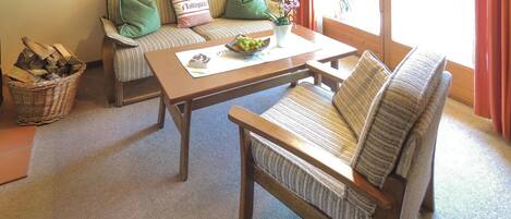 A cozy living room with a sofa, a wooden coffee table, and a wicker basket.