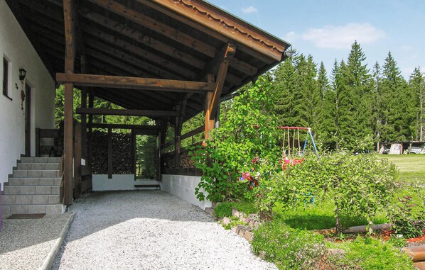 Step into a serene natural setting, surrounded by lush greenery and a charming garden area.