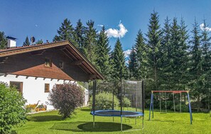 Enjoy a family-friendly stay in a traditional home surrounded by a lush garden with a trampoline and swing set.