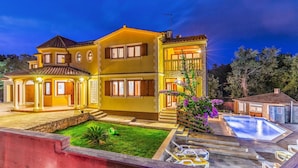 A two-story house with a swimming pool, a covered patio, and a well-maintained lawn. - Amazing home in Medulin (Medulin)