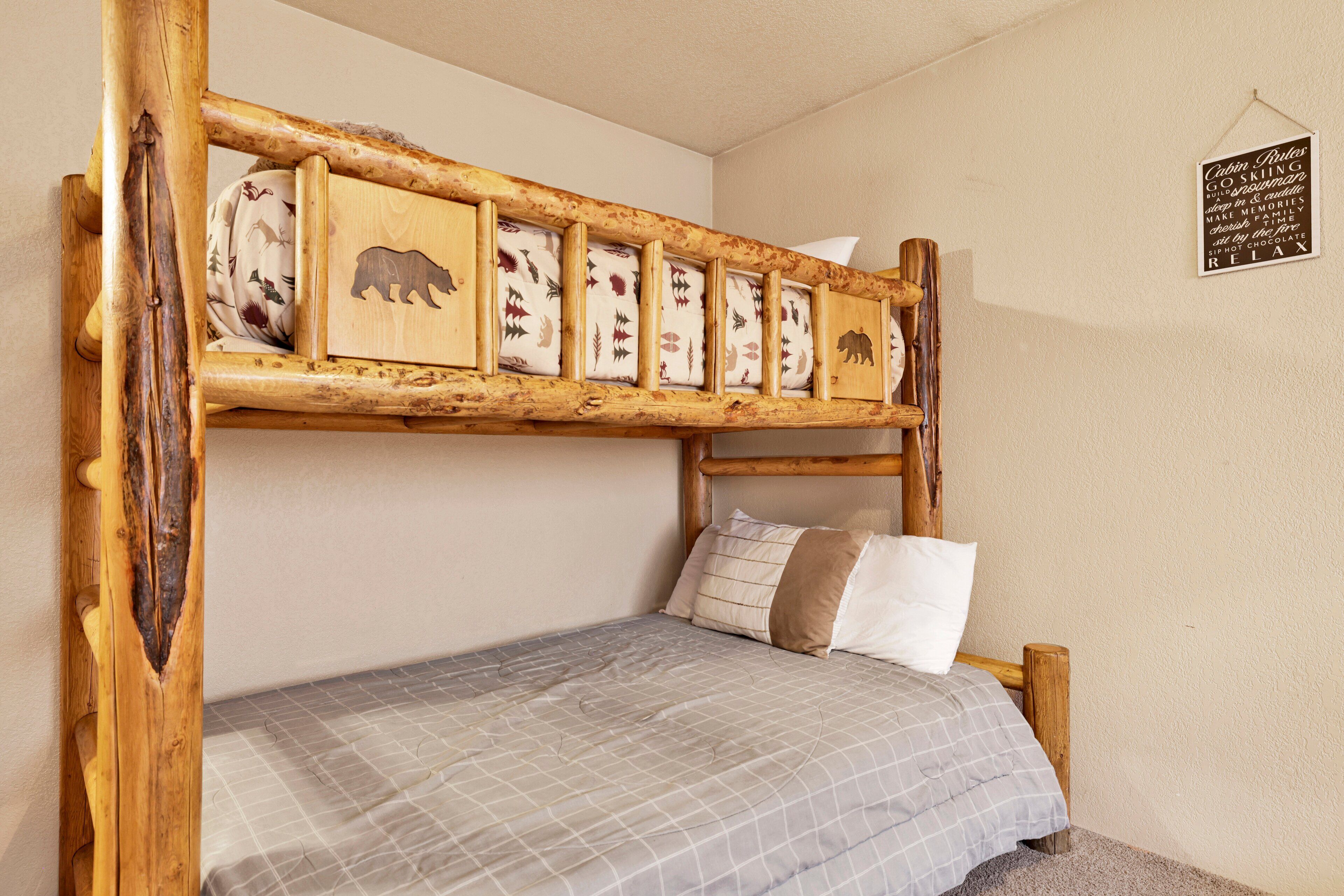 A bunk bed with a wooden frame and a headboard decorated with animal prints.