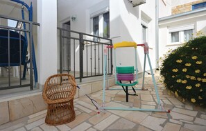 Relax in the outdoor space with a swing and climbing frame, perfect for kids to play. Enjoy the patio with a wicker chair and space for a game of badminton.