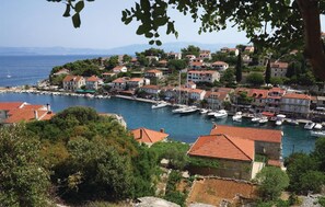 Stunning coastal town with a picturesque marina and scenic hillside views.
