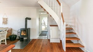 A staircase with wooden steps and white railings, leading to a door. - 3 bedroom awesome home in Hasle (Hasle)