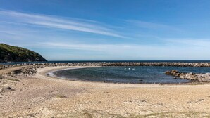 A coastal beach with clear skies, rocky shoreline, and a sandy area. - 3 bedroom awesome home in Hasle (Hasle)