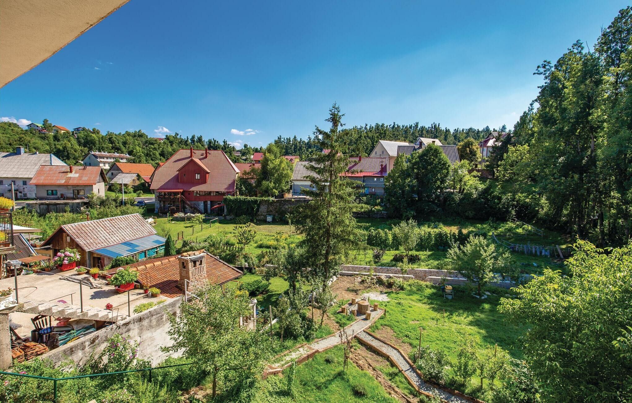 A rural village with houses, a swimming pool, and a garden.