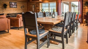 A wooden interior with a dining table, chairs, and a sofa. - 10 bedroom amazing home in ølen (Ølen)
