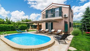 A two-story building with a swimming pool, outdoor seating, and a view of the landscape. - Luxurious home in Dicmo (Dicmo)