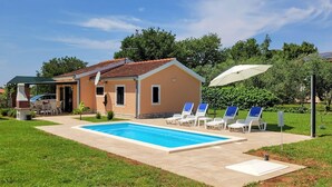 A house with a swimming pool, outdoor seating, and a barbecue area. - Lovely home in Medulin (Medulin)