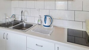 A kitchen with a stainless steel sink, a kettle, and a dish rack. - 1 bedroom lovely apartment in Klek (Klek)