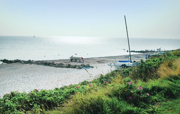 Enjoy a serene beachside escape with breathtaking ocean views and a picturesque rocky shoreline.