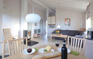 Relax in a cozy living space with a comfortable seating area, dining table, and modern fireplace.