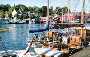 Overlooking a serene harbor with boats docked along the waterfront.