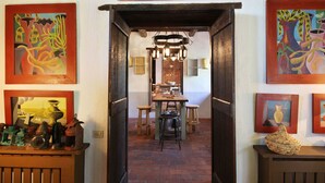 A hallway with a dining area, featuring a brick floor and wooden furniture. - Stunning private villa with WIFI, private pool, TV, patio and panoramic view, close to Lucca (Santo Stefano)