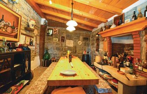 Enjoy a romantic dinner for two in this charming dining area with a long table, set with a single plate and knife.
