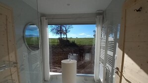 A bathroom with a large window, a round mirror, and a sink. - Authentic House with Spa and Pets Allowed (Saint-Forgeux-Lespinasse)
