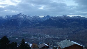 A mountainous landscape with a town below. - Mont-Rouge E 010 - VIEW apartment 8 pers (Veysonnaz)