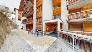 A multi-story hotel with wooden balconies and a stone facade. - Plein Ciel VA 032 - MOUNTAIN apartment 6 pers (Veysonnaz)