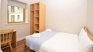 A bedroom with a bed, a wooden wardrobe, a desk, and a window. - Apartment 702 Letterfrack - sleeps 4 guests  in 3 bedrooms (Unknown)