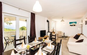 Enjoy a serene atmosphere with a view of lush greenery from the large window, perfect for relaxation or conversation.